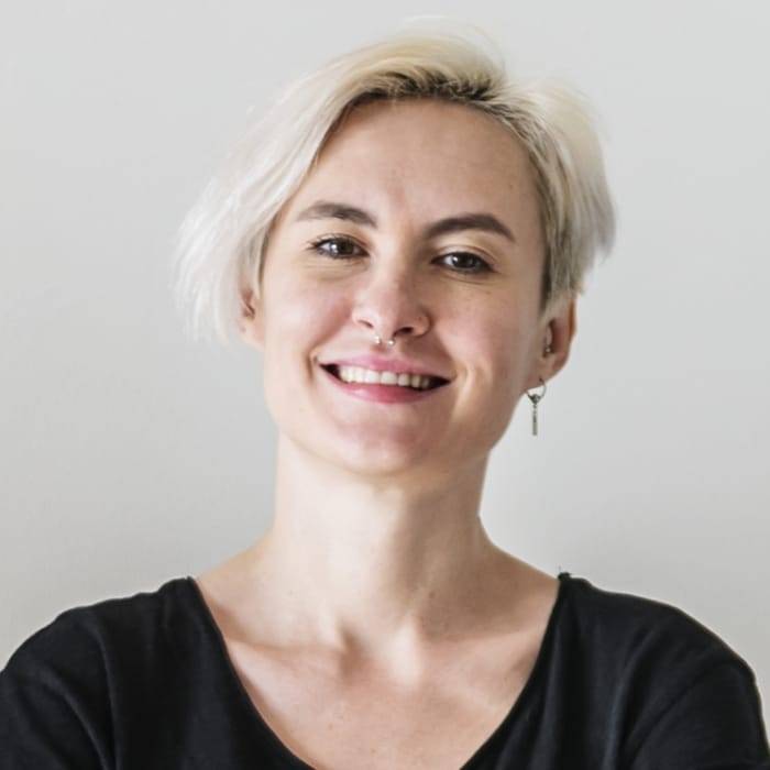 Smiling woman with short blonde hair, wearing a black shirt, representing satisfied customer feedback for OMW Locksmith services.
