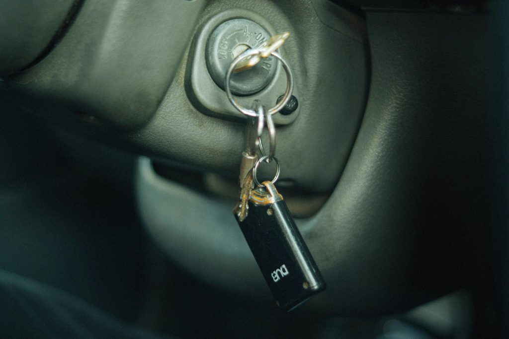 Car ignition with keys, highlighting a key fob, relevant to locksmith services and car key replacement in Harrisburg and Kingdom City, MO.