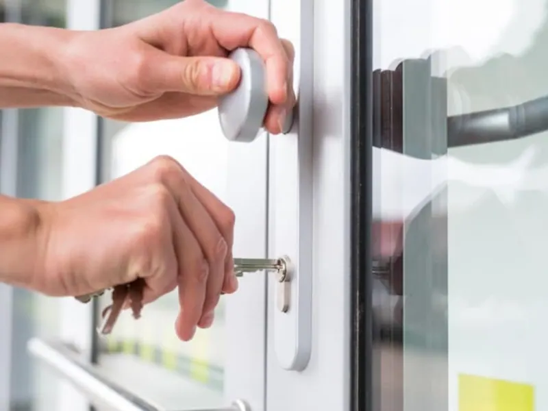Person unlocking a door with a key, demonstrating locksmith services for home lockout assistance in Columbia, MO.